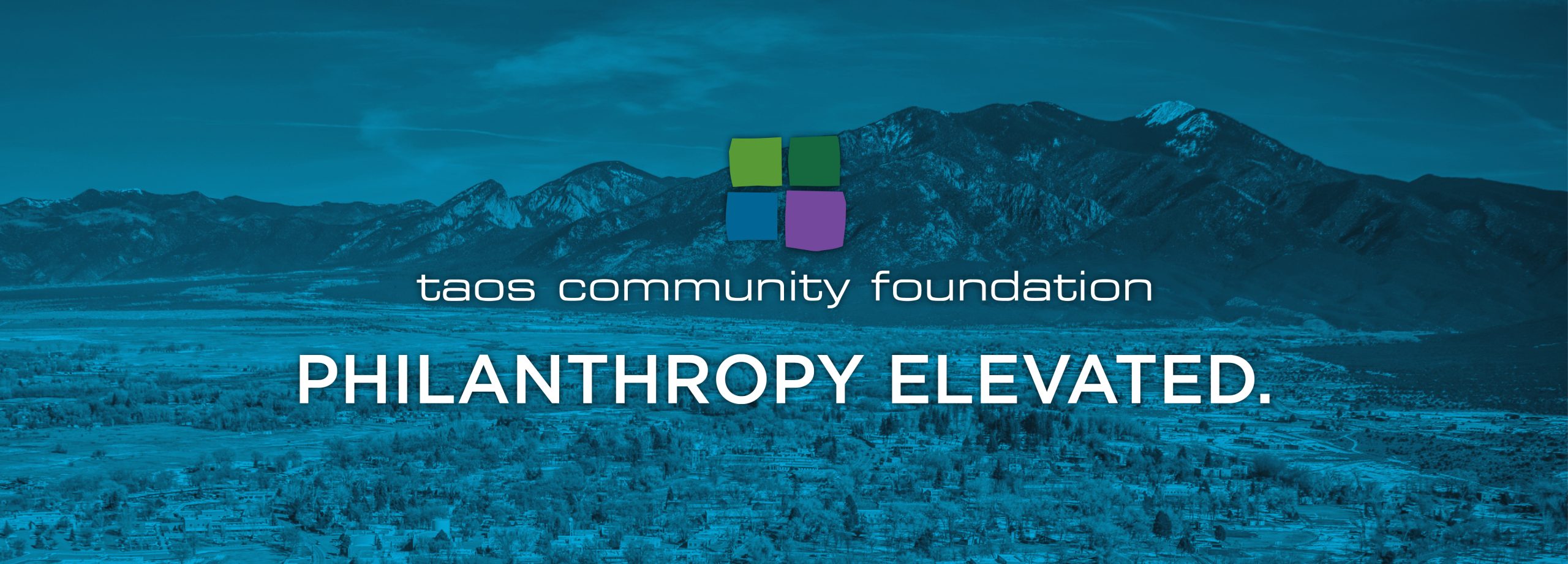 Logo of Taos Community Foundation over a picture of Taos New Mexico, with the words "Philanthropy Elevated."